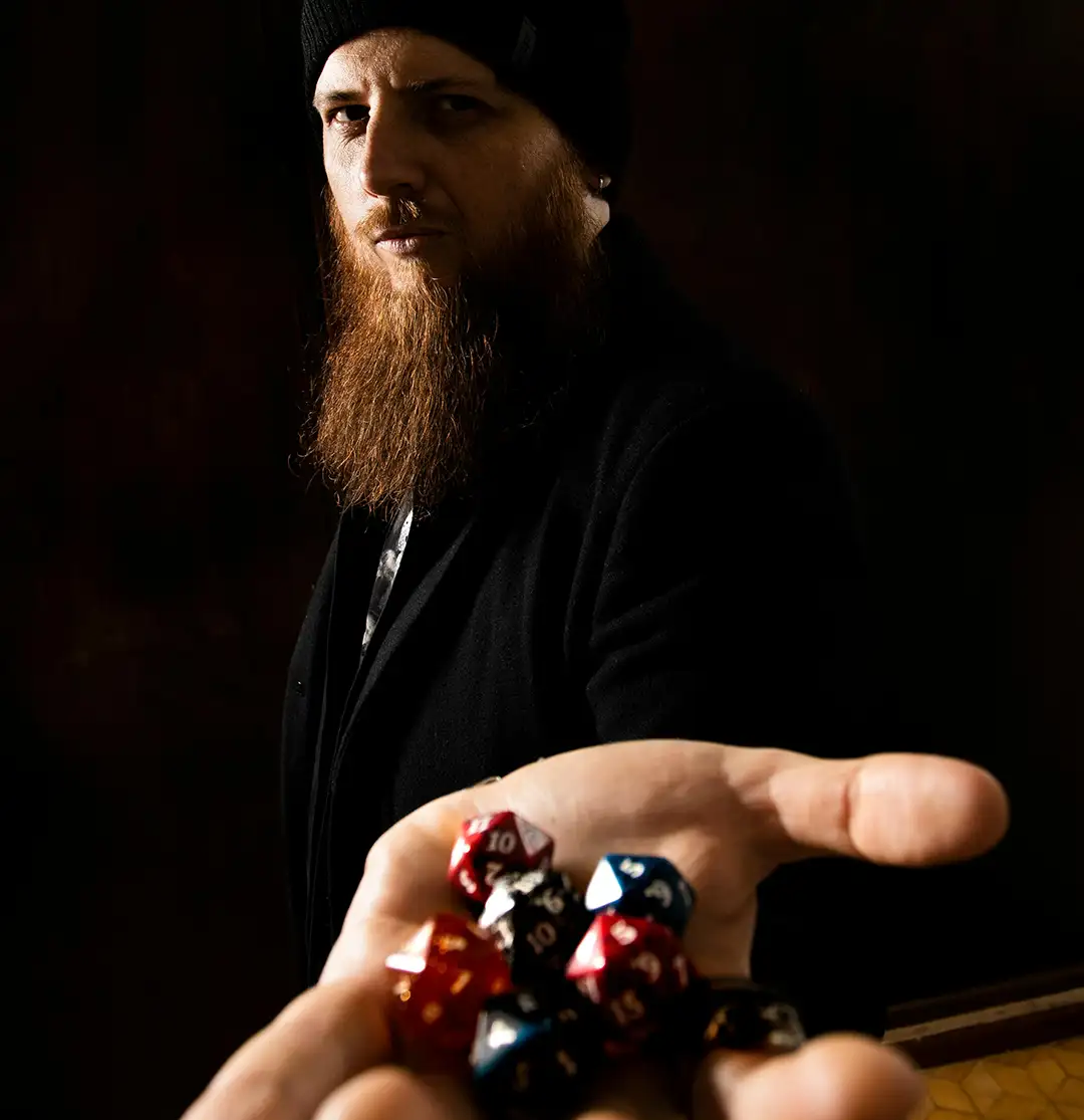 How To Start DM'ing In 2026 dungeons and dragons blog dice hedron ominous man holding dice Dm Dungeon Master